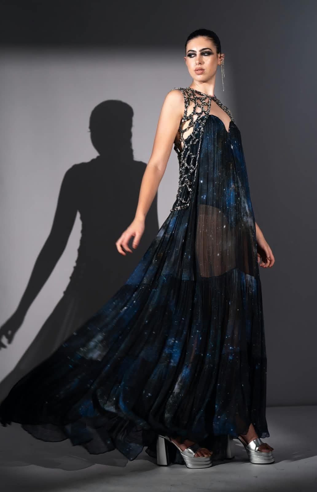 The Celestia gown in motion, the printed chiffon lifting as the model walks.